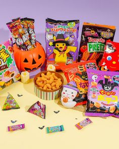 halloween treats and candy are arranged on a table