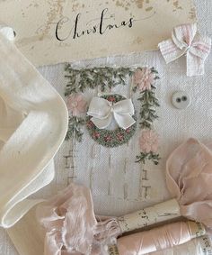 a white table topped with lots of different types of cloths and bows on top of it