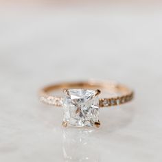 an engagement ring with a princess cut diamond