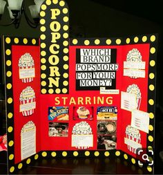 a pop corn movie display with popcorn on the front and back panels, along with other items