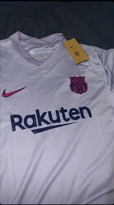 the shirt is white and has purple letters on it, which read rakuten