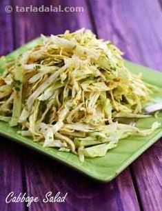 a green plate topped with shredded cabbage