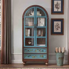 a blue china cabinet sitting in the corner of a room