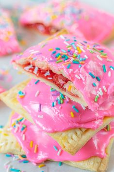 pink sprinkle covered cookies stacked on top of each other