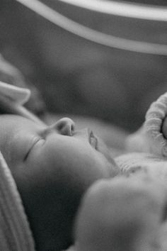 a black and white photo of a baby sleeping