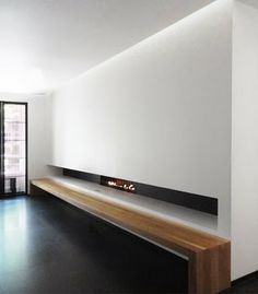 an empty room with a fireplace in the center