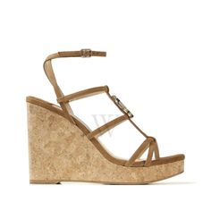 Jimmy Choo Ladies Heels. SKU: JC WEDGE 110 SUE. Color: Cuoio. Fashioned from cuoio suede, our design showcases a T-bar strap and delicate ankle strap that elegantly wraps and secures the foot. Elevated on a 110mm wedge height, it is adorned with our iconic gold JC emblem. Made in Italy. Please visit the brand website for sizing information. Ladies Heels, Brand Website, Versace Watch, Fine Pens, Cheap Gifts, Denim Shoes, Leather Wedge Sandals, Fragrance Gift Set, Crossbody Messenger Bag