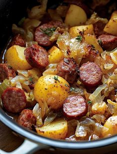 sausage, potatoes and onions cooking in a pot