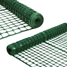 two pieces of green wire mesh are laying on top of each other and one piece is rolled up