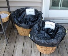 two trash bags sitting on top of a wooden deck