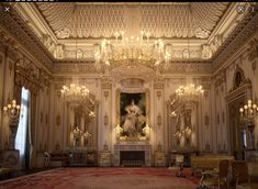 an ornately decorated room with chandeliers and paintings