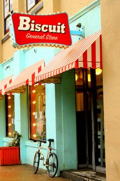 a bicycle is parked in front of biscuit general store