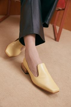 The Olympia Loafer is a babouche-inspired loafer featuring a square boxy toe, a cut-away upper, and a stacked leather heel. Olympia sets itself apart from the typical loafer thanks to its elegant lines. Style the Olympia loafer with suiting for a modern work look or with slip dresses for an elevated, relaxed evening look. Who it’s for: The woman who loves loafers and is looking for a fresh new shape to experiment with. Handmade in Argentina Kidskin leather upper with vegetable tanned leather lin Chic Slip-ons With Leather Sole And Low Heel, Classic Slip-on Flats With Square Toe, Square Toe Leather Shoes For Office In Spring, Square Toe Leather Shoes For Spring Office Wear, Spring Formal Calf Leather Slip-ons, Formal Calf Leather Slip-ons For Spring, Spring Office Leather Shoes With Square Toe, Chic Leather Shoes With Removable Insole And Square Toe, Classic Square Toe Flats With Leather Sole