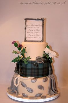 a three tiered cake decorated with leaves and flowers