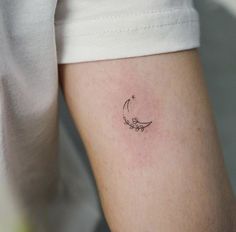 a woman's arm with a small tattoo on the left side of her body