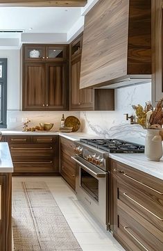 a kitchen with wooden cabinets and marble counter tops