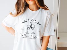 a woman wearing a napa valley wine club t - shirt