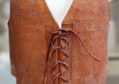 a piece of brown leather with laces on it