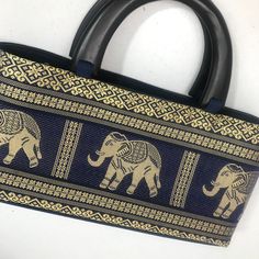 One of a kind women's handbag. Bought in Bangkok as a gift but never used. Beautiful gold and navy design with traditional Thai elephants. Luxury Traditional Bags For Vacation, Asian Handbags, Thai Elephant Art, Thai Elephant, Thailand Travel Elephants, Chanel Deauville Tote Bag, Women Handbags, Elephant, Chanel