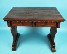 an old wooden table with two drawers on one side and another drawer on the other