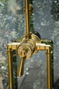 an old fashioned brass faucet in front of a window