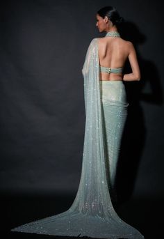 Editor's Note Featuring a pre-draped sari in refreshing shade of mint green paired with halter blouse Fabric: Net Color: Mint green Neckline: Halter Sleeve type: Sleeveless Component: Sari and ... Glamorous Green Choli For Wedding, Glamorous Green Wedding Choli, Glamorous Fitted Green Choli, Green Saree In Traditional Drape For Party, Green Pre-draped Saree For Party, Green Traditional Drape Blouse Piece For Party Wear, Fitted Green Choli For Evening Wear, Fitted Green Choli For Evening, Pista Green Saree With Unstitched Blouse For Party