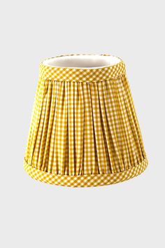 a yellow and white gingham lampshade with pleated fabric on the bottom