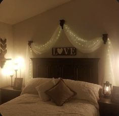 there is a bed with lights on the headboard