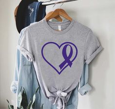 "Lupus Heart Shirt,Lupus Awareness Tee,Gift For Lupus Survivor,Purple Ribbon Heart TShirt,Lupus Fighter Tee,Support Lupus,Lupus Warrior Shirt ----- How To Order ----- 1-) Please, check and review all the photos. 2-) Choose your t-shirt size and color. *Different styles of shirts may have different shades of same color choice due to different manufacturer brands. *For this reason, we recommend you to match shirts from the same styles if you want precisely matching colors (ex. Unisex, V-necks, Tod Purple T-shirt For Awareness Events With Letter Print, Purple T-shirt With Letter Print For Awareness Events, Purple Casual Top For Awareness Events, Casual Purple Top For Awareness Events, Alopecia Awareness, Ribbon Heart, Heart Tshirt, Warriors Shirt, Ribbon Shirt