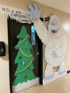 two doors decorated to look like christmas trees and yeti or not, the ghost is coming