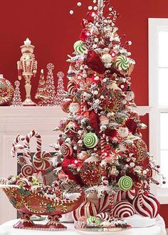 a christmas tree decorated with candy canes and candies in front of a window