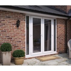 an image of a patio with sliding glass doors and potted plants on the side