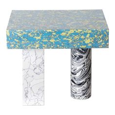 a blue and white table with two marble pillars on it's sides, one in the shape of a rectangle