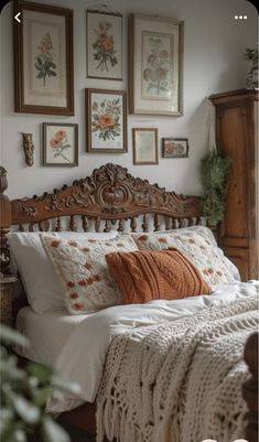 a bedroom with pictures on the wall above the headboard and an old fashioned bed