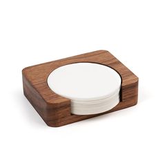 the coaster is made out of wood and has white plates on it, along with a wooden stand