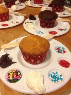 several cupcakes are on plates with spoons