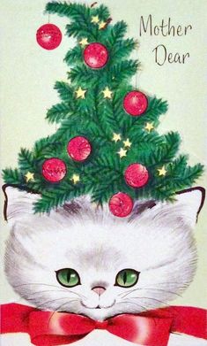 a white cat wearing a red bow around its neck with a christmas tree on it's head