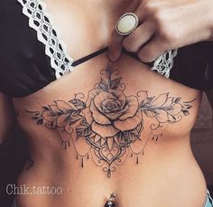 a woman with a rose tattoo on her stomach