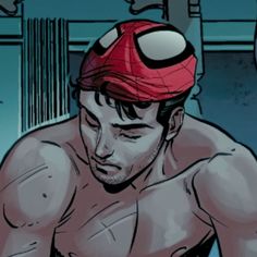 a man with a red hat on his head and no shirt is looking down at something