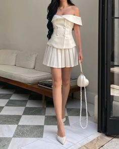 Meshki, off the shoulder top, ootd, pleated mini skirt, simone rocha heart pearl bag, elegant style, fashion inspo, outfit idea, pointed toe heels, double breasted button top Pleated Mini Skirt Outfit Ideas, White Off Shoulder Top Outfits, Skirt And Heels Outfit, Off Shoulder Top With Skirt, Pleated Top Outfit, White Off The Shoulder Top Outfit, White Elegant Outfit, One Shoulder Outfit, Elegant White Outfit