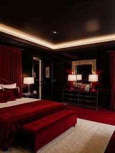 a bedroom with red velvet bedding and white rugs