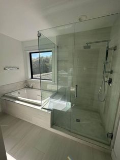 a bathroom with a large glass shower door