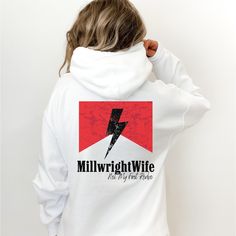 Introducing the Millwright Wife Hoodie - a perfect blend of comfort, style, and pride for the hardworking wives of Millwright heroes. This western-style hoodie is designed to celebrate the strength and resilience of those who support Millwright Workers and the blue collar life. Key Features: Premium Quality: Made from high-quality, soft, and durable fabric to keep you warm and cozy. Stylish Design: Western-inspired design with a bold "Blue Collar Wife" print that stands out. Versatile Wear: Perf Blue Spread Collar Shirt With Graphic Print, Light Blue Graphic Print Sweatshirt For Winter, Blue Collar Brat Shirt, Blue Collar Wife Shirt, Light Blue Hooded Sweatshirt With Letter Print, Blue Collar Wife, Wife Sweatshirt, San Jose Ca, Style Hoodie