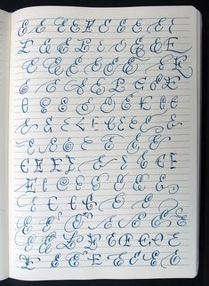 an open notebook with cursive writing on the pages and numbers in blue ink