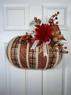 a decorative pumpkin hanging on the front door