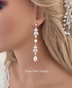 a close up of a woman's face wearing earrings with pearls and leaves on them