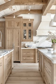 a large kitchen with wooden cabinets and white counter tops, along with an island in the middle