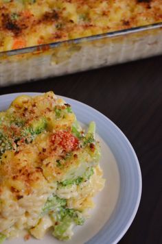 a casserole dish with broccoli and cheese on a plate next to the casserole