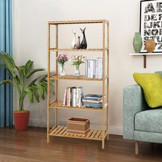 a living room with a couch, chair and bookshelf on the floor in front of a window