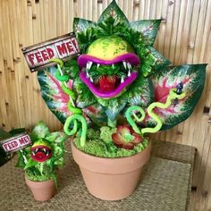 a potted plant that has some plants in it and is decorated with fake food